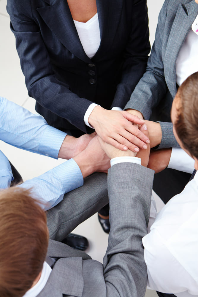 Colleagues celebrating a successful project with a high five