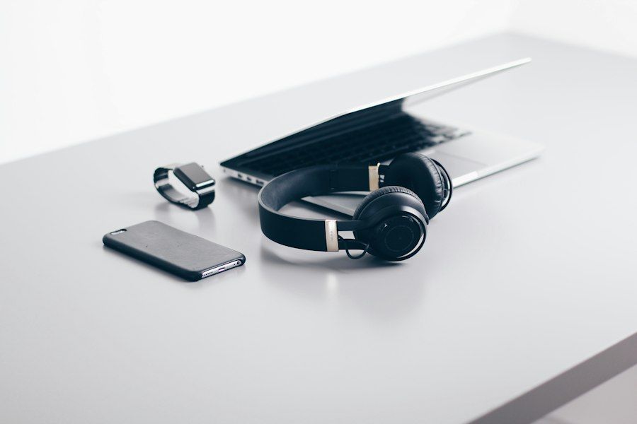 Laptop, headphones and smartphone on a desk