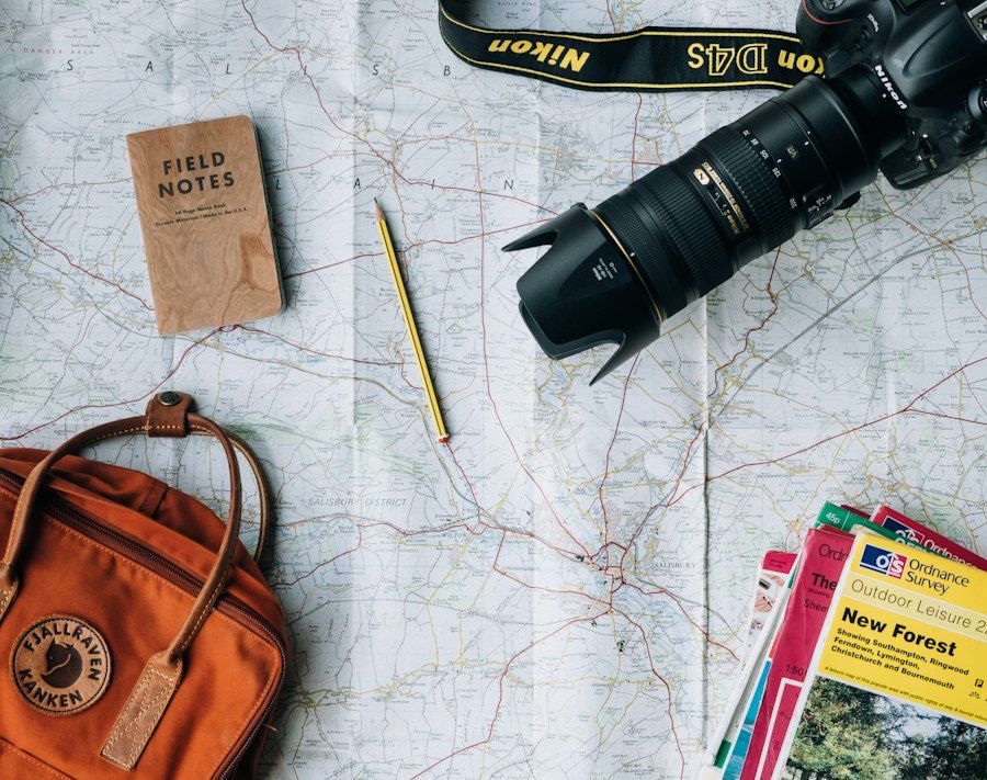 Map, camera and backpack prepared for a trip